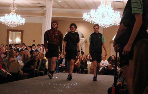 Michael (center) and his longtime friends Alex (left) and Jackson (right) strut down stage at this year's Senior Showcase. 