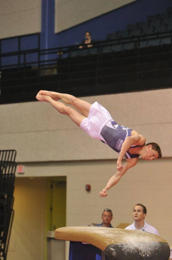Bailey Perez, senior, completing a flip in a gymnastics routine