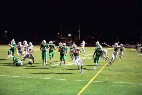 Senior Keith Bowers holds the ball tightly as he makes his way into the end zone.