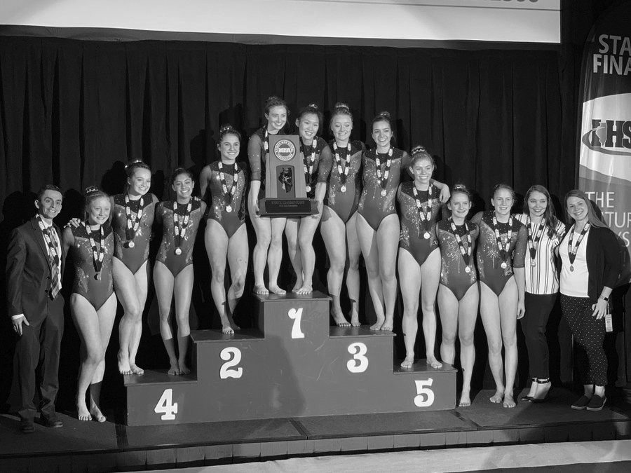 The+Girls+Gymnastics+Team+celebrates+their+back-to-back+State+Championship+status+at+awards+during+the+IHSA+Gymnastics+State+Competition.+Key+athletes+for+West%E2%80%99s+win+included+Maddie+Diab%2C+Maia+Lee%2C+Taylor+Ramirez%2C+and+Claire+McGurck%2C+all+seniors.+