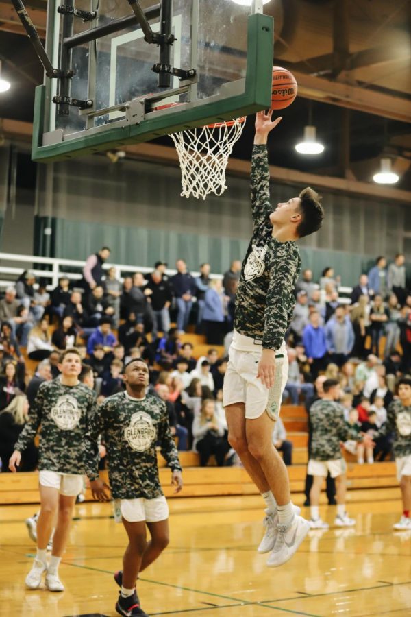 Danny Mulcare (junior) making a basket during team warm ups. 