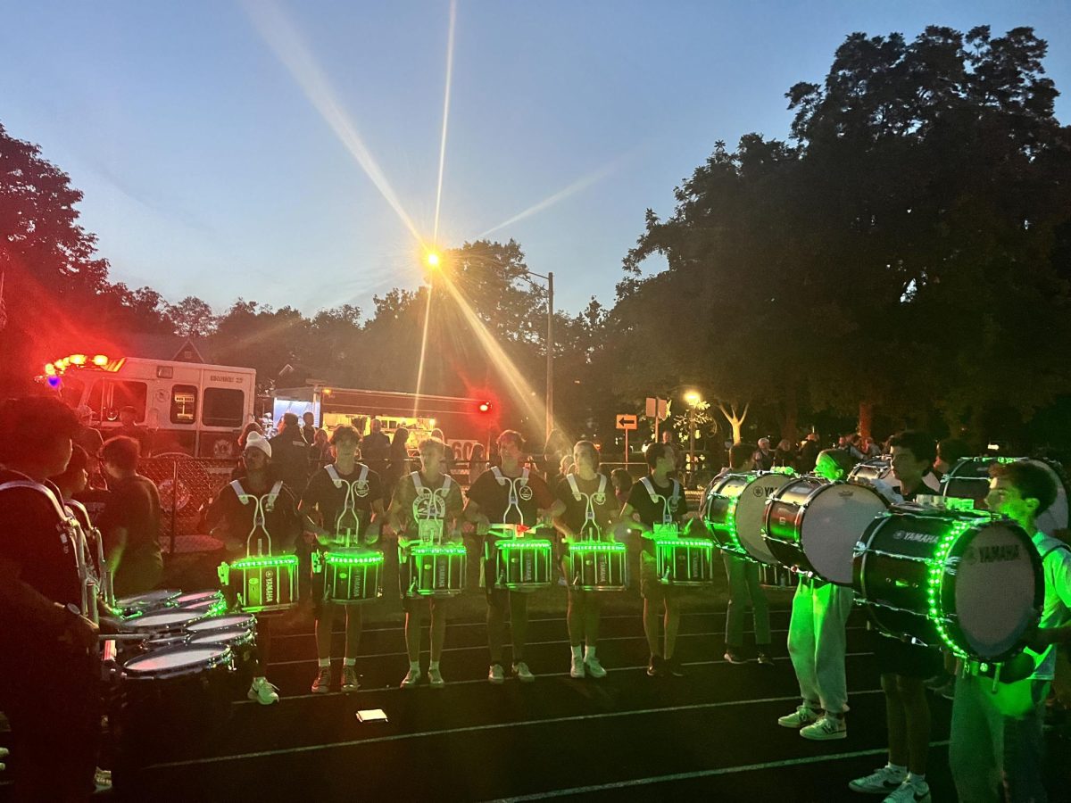 West’s drumline livens up the night, all while glowing in Glenbard Green.
