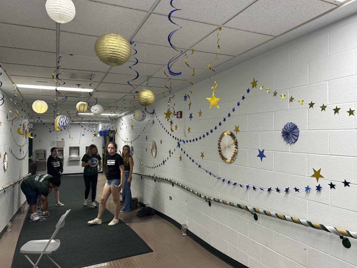 Glenbard West’s Student Council stays late into the night after the bonfire to decorate Biester and the Fieldhouse for the dance.